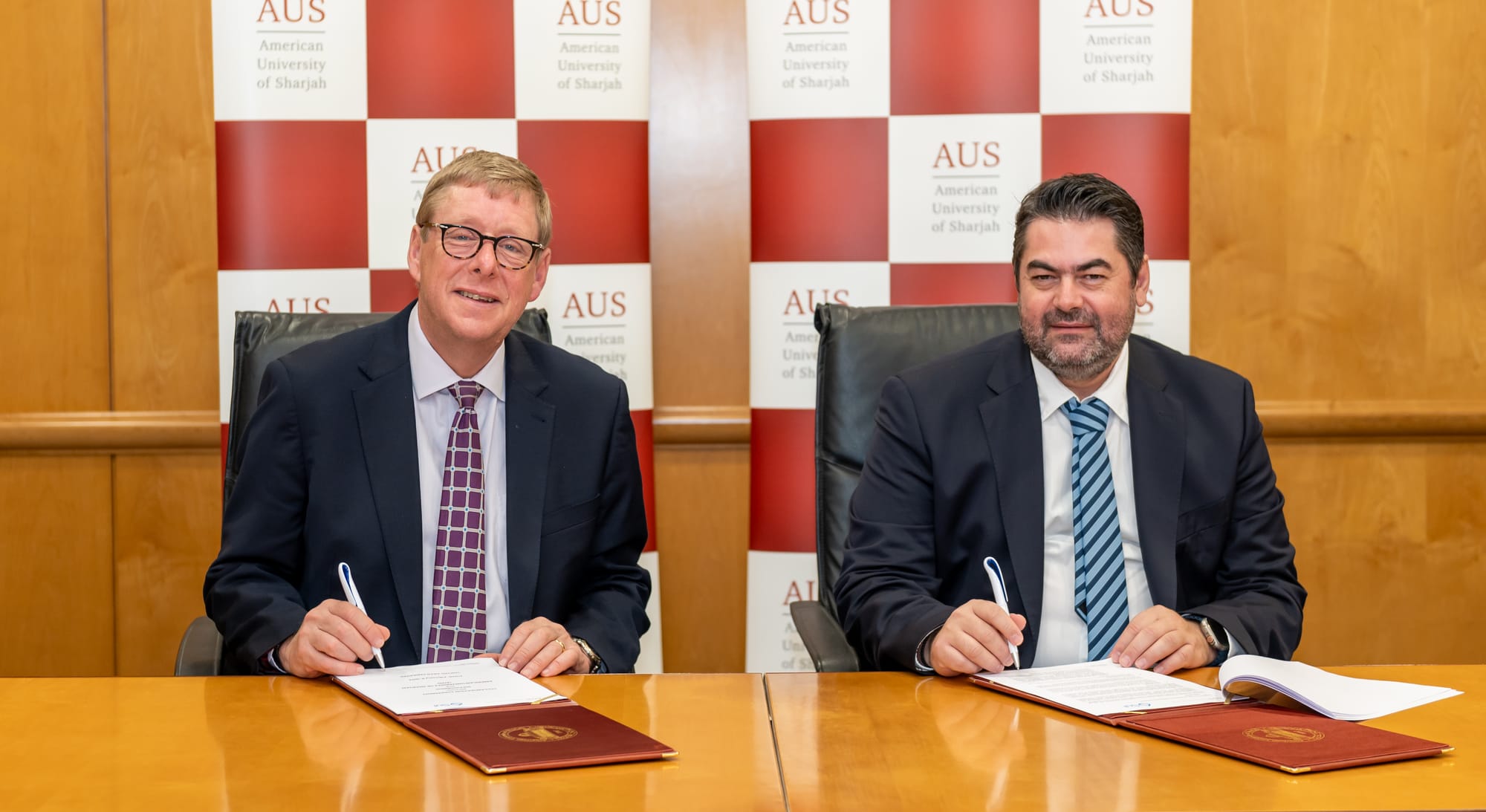 Dr. Tod Alan Laursen, Chancellor of AUS, and Dr. Greg Siourounis, Managing Director of the Sui Foundation, signing documents